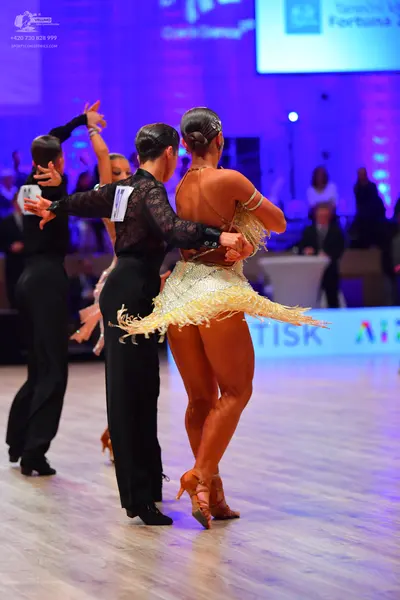 Dancesport competitor: Male dancer (left): black long-sleeved shirt and black trousers
