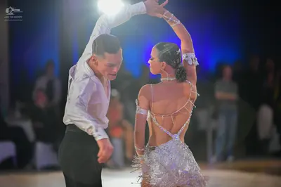 Dancesport competitor: Male dancer: white long-sleeved shirt and black trousers