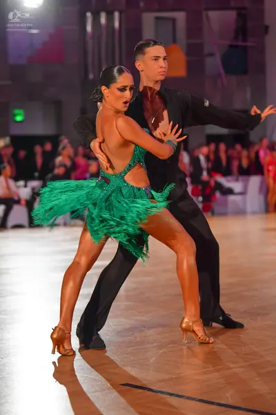 Dancesport competitor: Male dancer: black long-sleeved shirt and black trousers