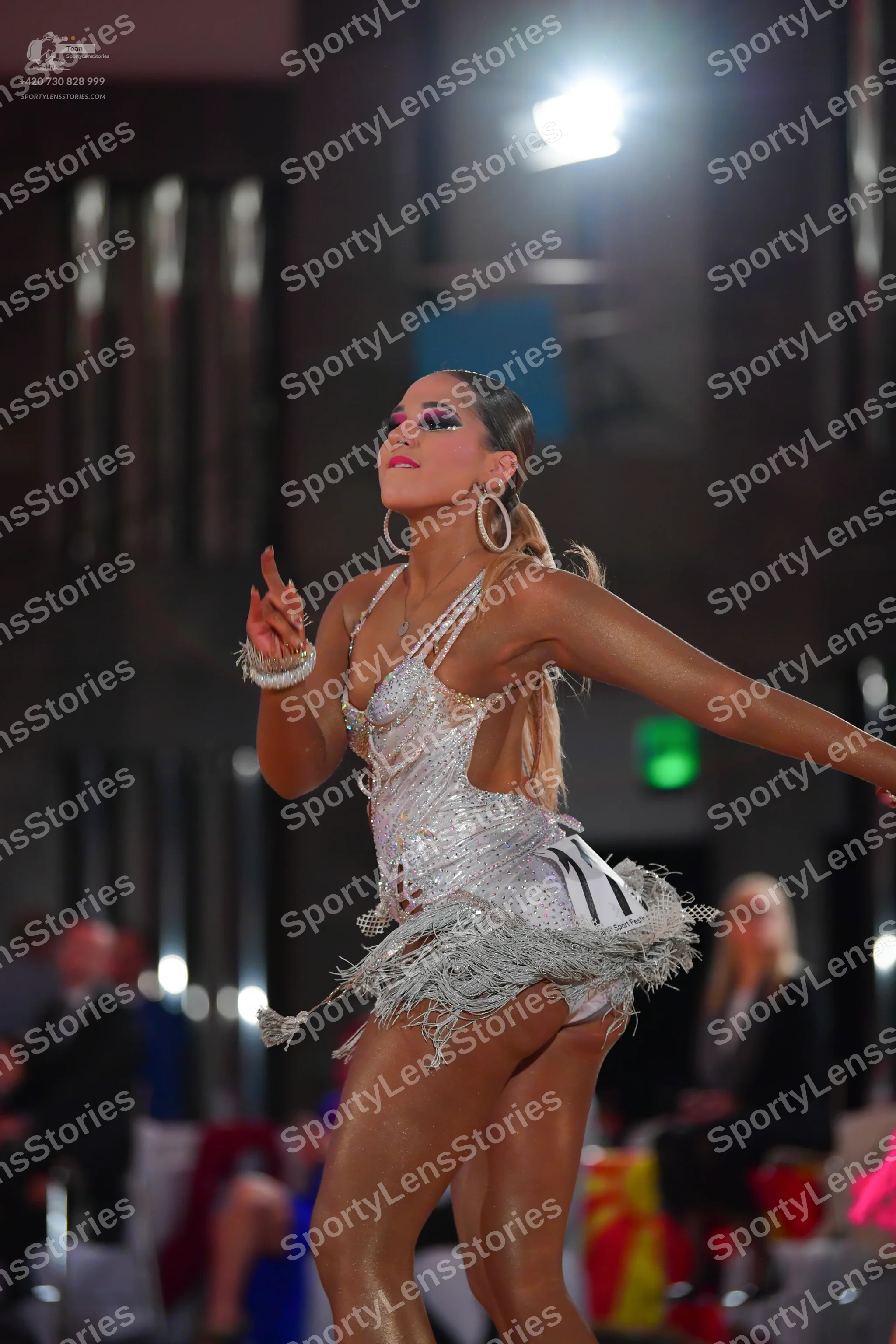 Dancesport competitor #11: Female dancer: silver sequin latin dress with thin straps, heavy crystal embelli
