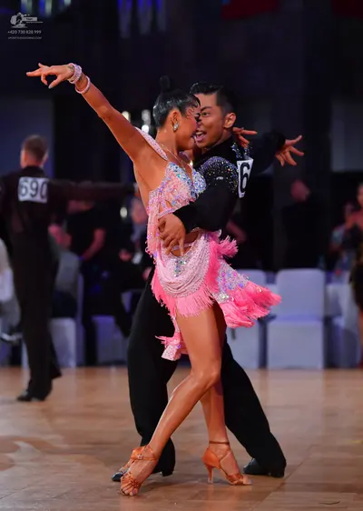 Dancesport competitor #690: Male dancer: black long-sleeved shirt with silver sequins on the shoulder and bl