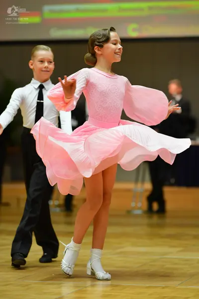 Dancesport competitor: Male dancer: white long-sleeved shirt, black necktie, and black trousers