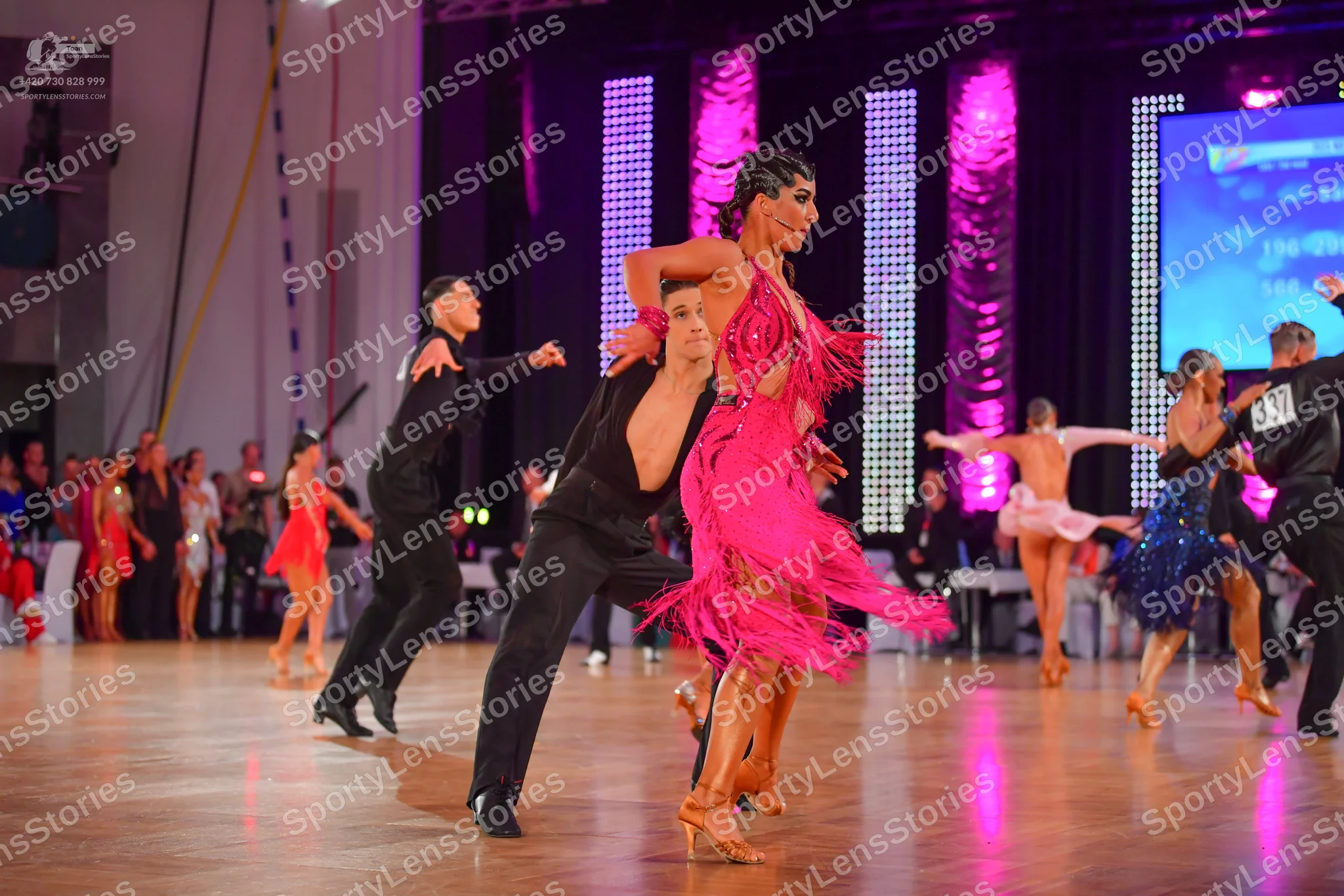 Dancesport competitor: Male dancer (center): black long-sleeve shirt and black trousers