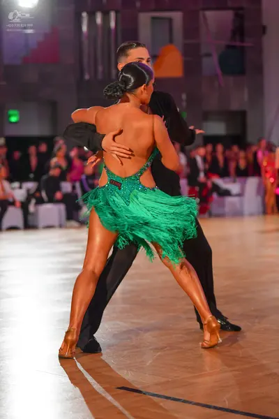 Dancesport competitor: Male dancer: black long-sleeve shirt and black trousers