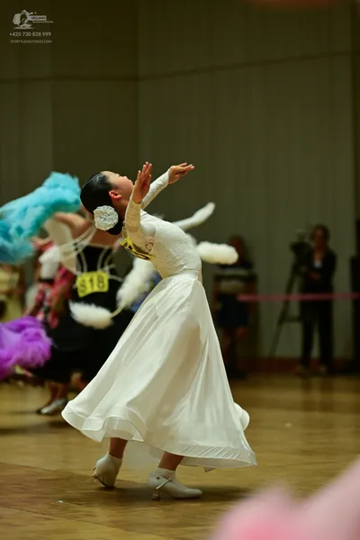 Dancesport competitor: ** White Latin dress
*   **Fabric:** Satin (appears to be a lightweight satin wi