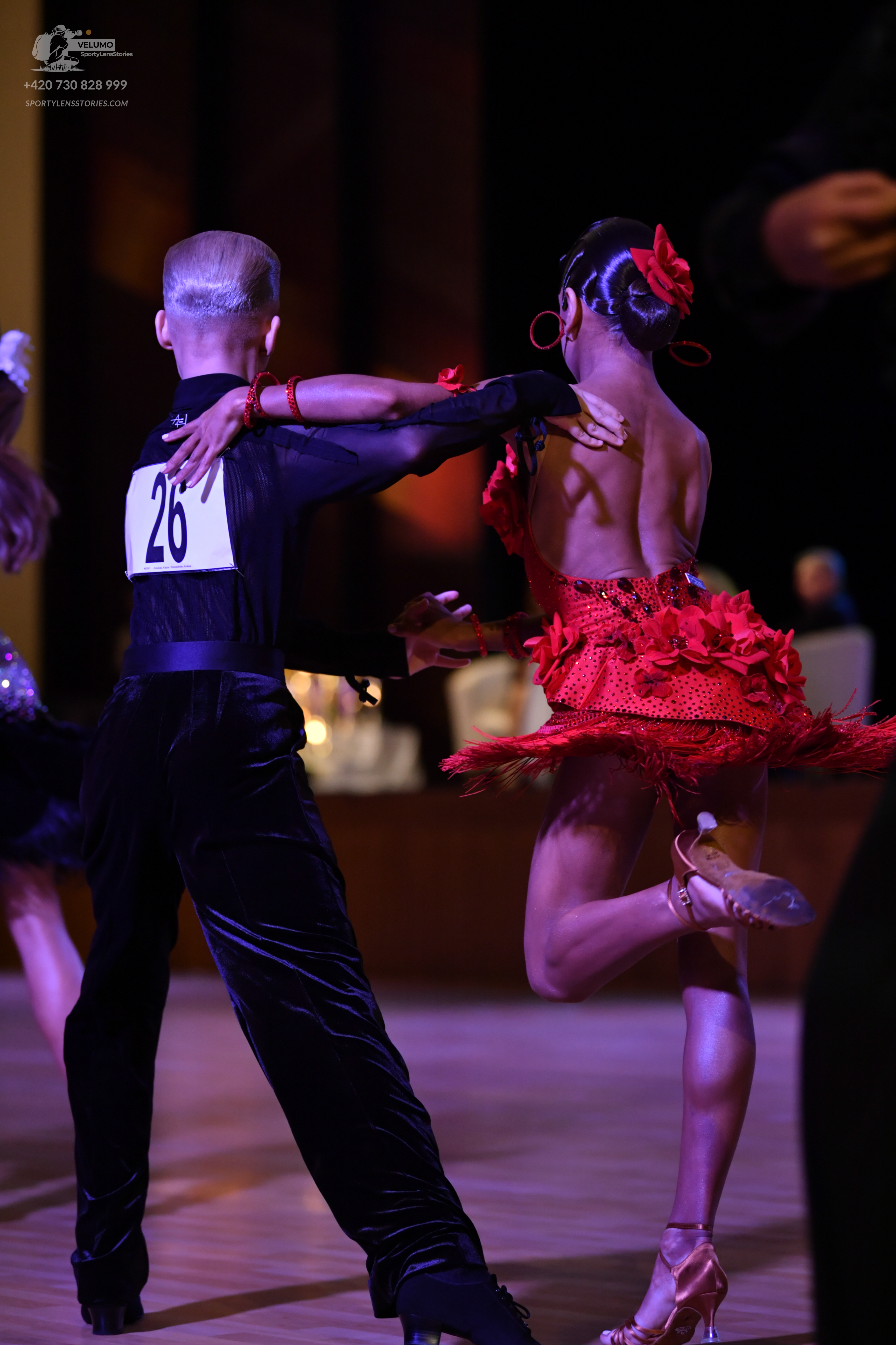 Dancesport competitor: Male:** Black tail suit with sequin lapels
