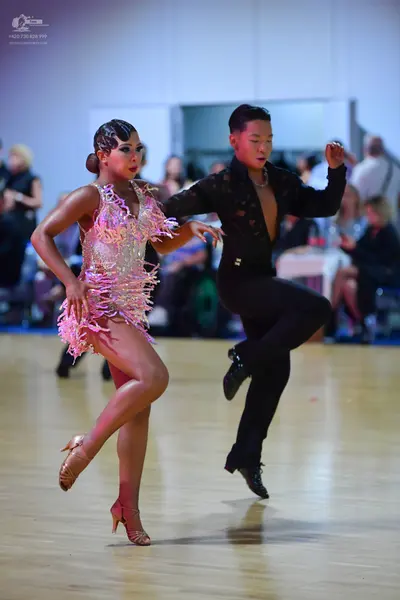Dancesport competitor: Female dancer: light pink/nude Latin dance dress with sequins and lace-like patt