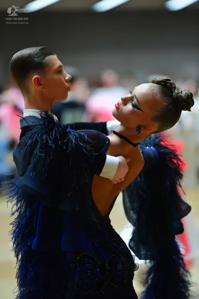 Dancesport competitor: Male dancer: black suit jacket with a white shirt collar