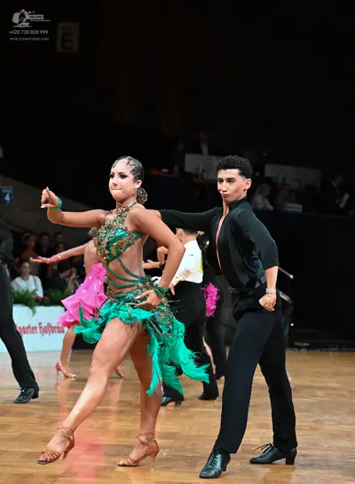 Dancesport competitor: Male dancer: black long-sleeve shirt and black trousers