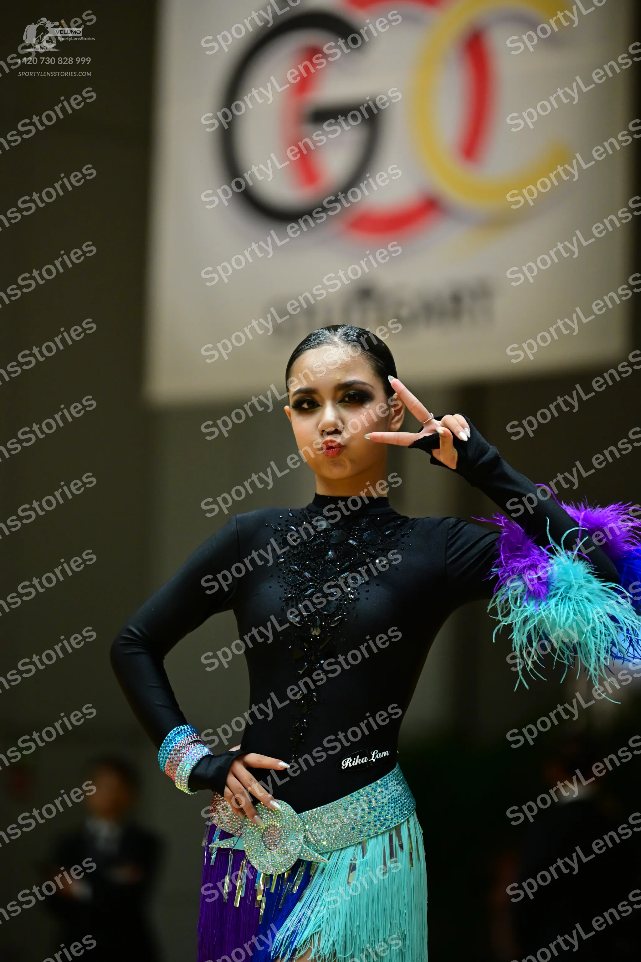 Dancesport competitor: Female dancer: black long-sleeved latin dress with black sequin/beadwork on the