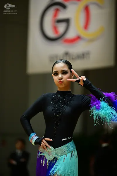 Dancesport competitor: Female dancer: black long-sleeved latin dress with black sequin/beadwork on the 