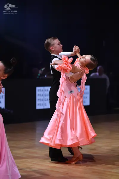 Dancesport competitor: Male dancer: black waistcoat over a white shirt and black trousers