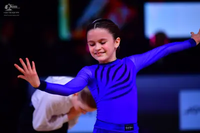 Dancesport competitor: Female dancer: blue long-sleeved top with black tiger-stripe pattern