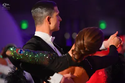 Dancesport competitor: Male dancer: black suit with a white shirt and white bow tie