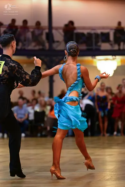 Dancesport competitor #73: Male dancer: black long-sleeved shirt with a floral lace pattern and black trous