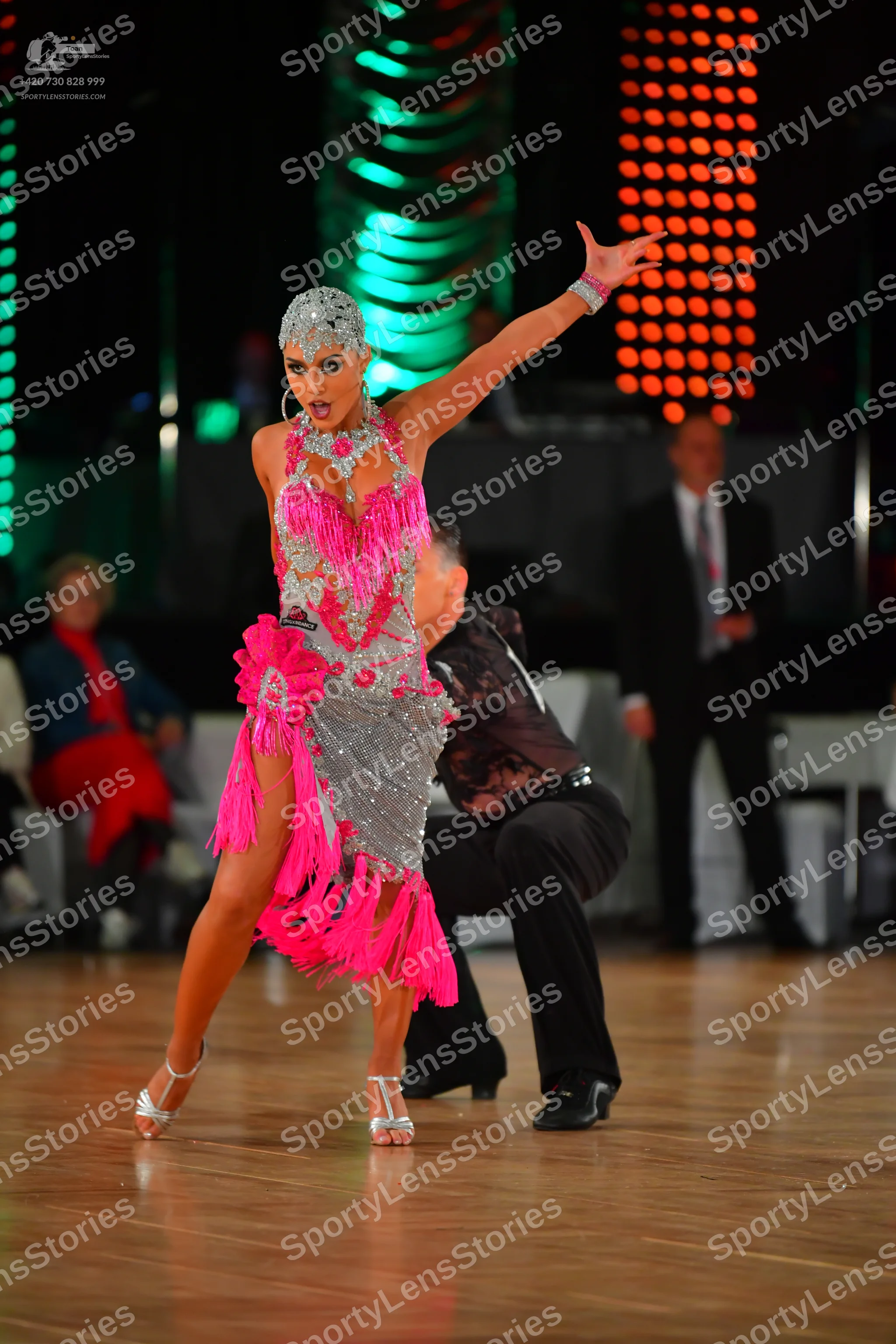 Dancesport competitor: Female dancer: silver sequin Latin dress with bright pink fringe, matching silve
