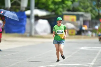 Marathon runner #5368: Runner 1: green jersey, blue shorts, black shoes, green cap