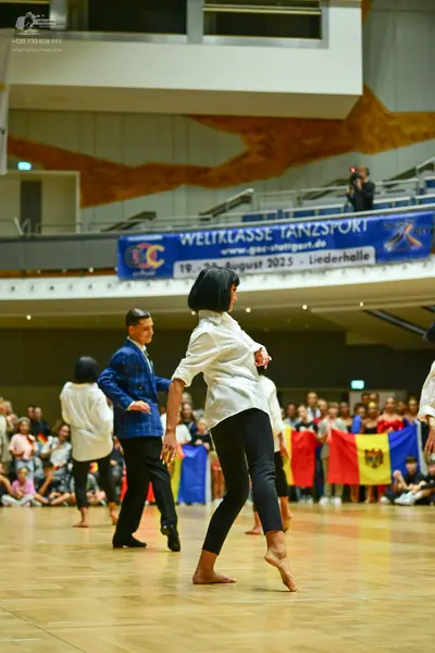 Dancesport competitor: Male dancer in blue: blue patterned suit jacket and black trousers