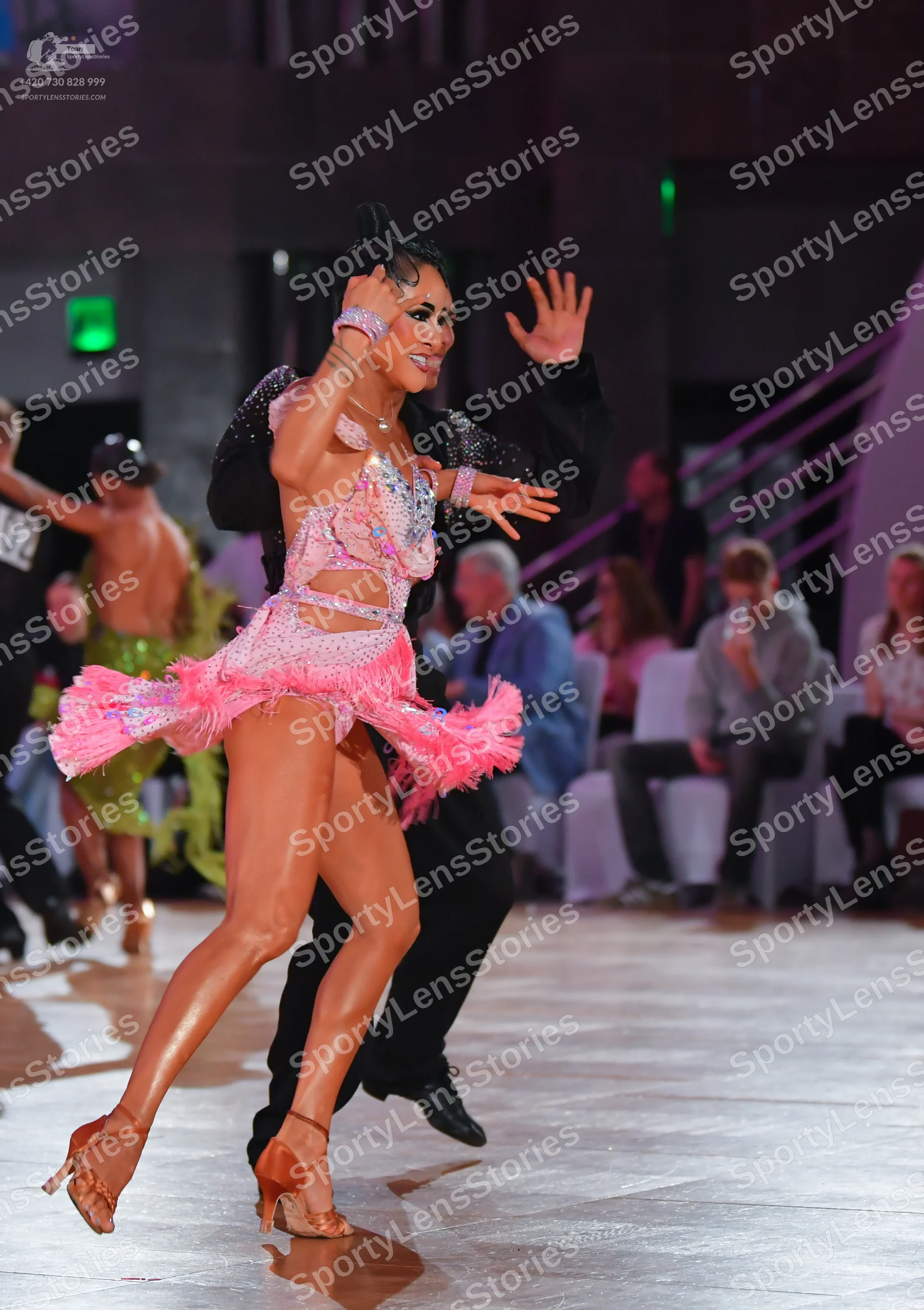 Dancesport competitor #02: Main female dancer: pink latin dress with sequins, cut-outs, and pink fringe