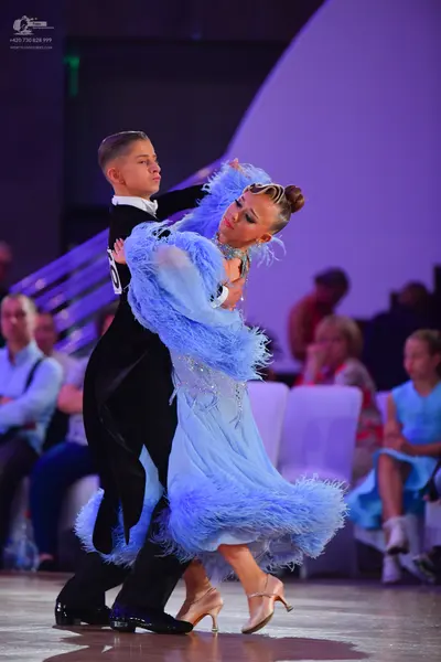 Dancesport competitor: Male dancer: black ballroom tailcoat with a white shirt