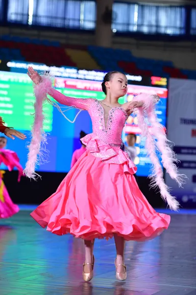 Dancesport competitor: ** Female: Pink, voluminous ballroom gown