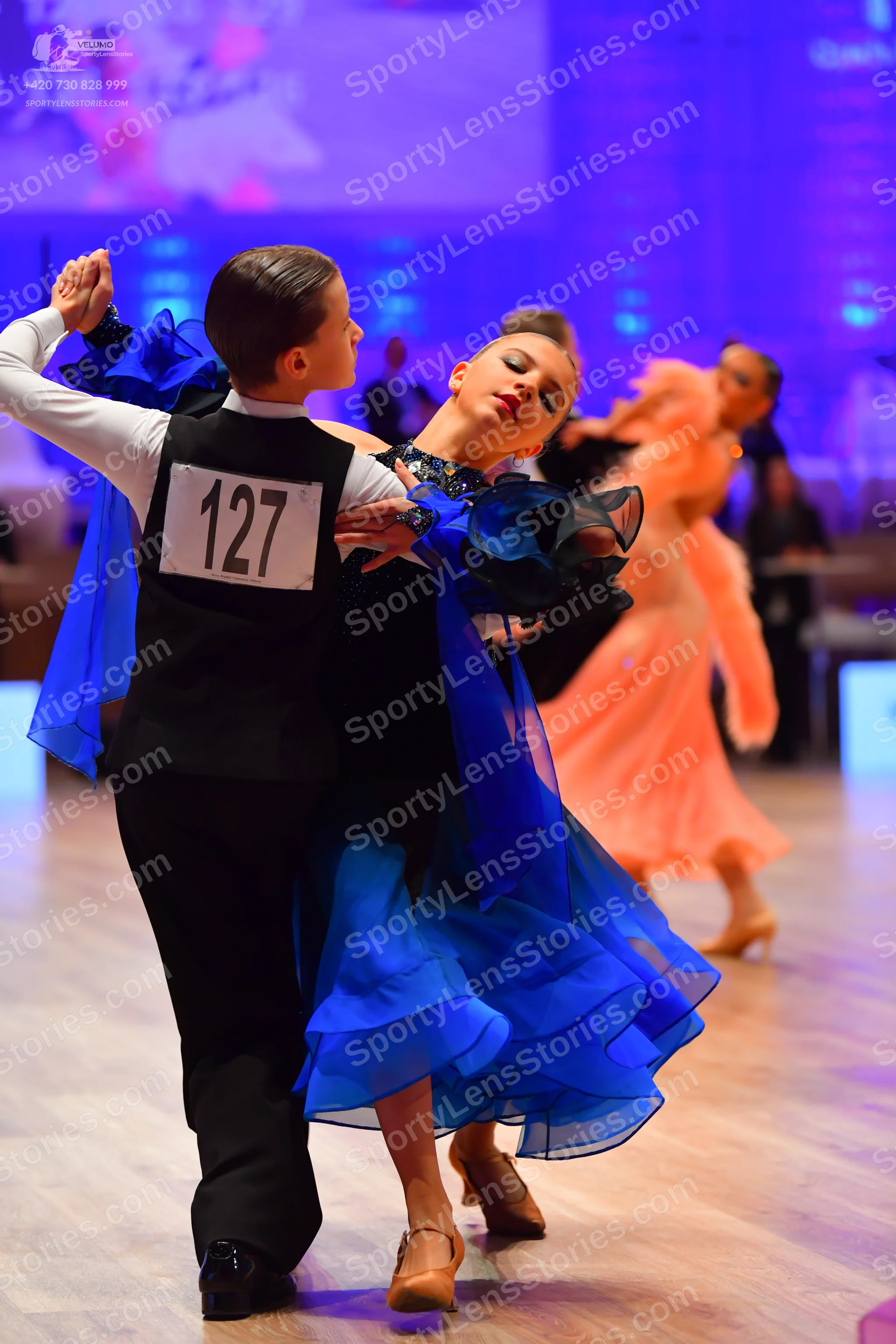 Dancesport competitor: Male dancer: white long-sleeved shirt, black waistcoat, and black trousers