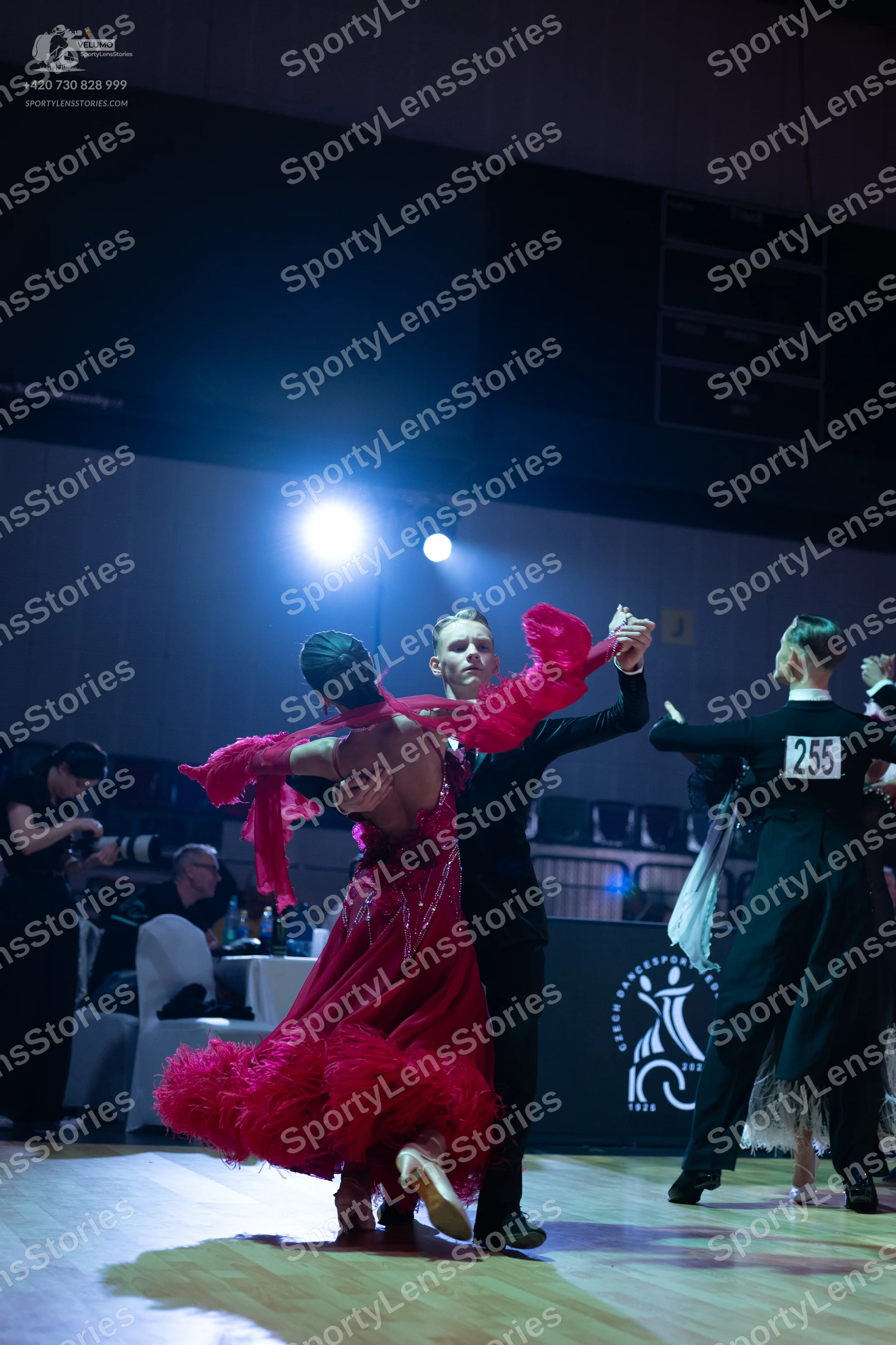 Dancesport competitor: Female dancer (foreground): pink latin dress with fringe
