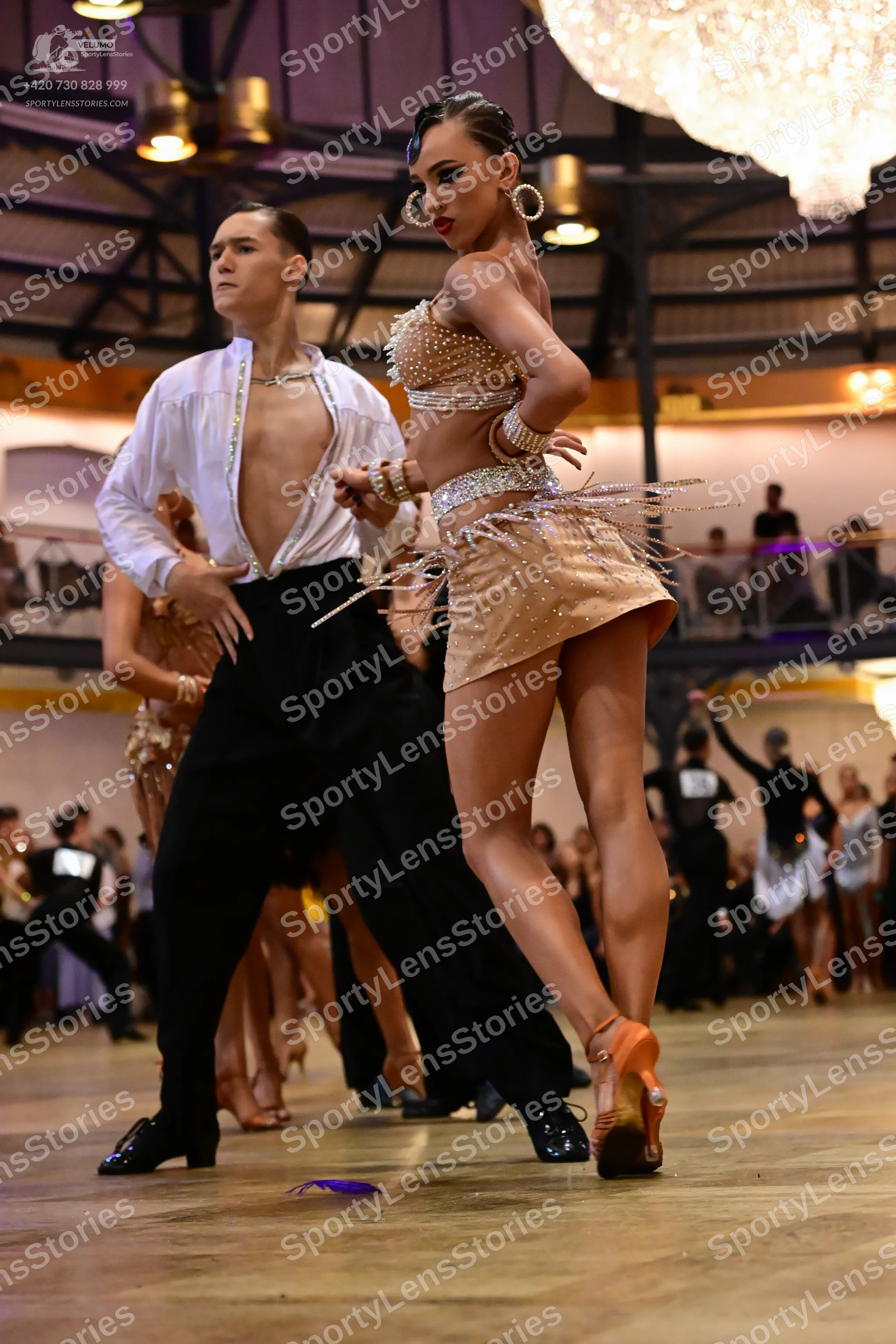 Dancesport competitor: Male dancer: white long-sleeved shirt open at the chest and black trousers