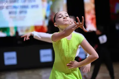 Dancesport competitor: Female dancer: lime green short-sleeved dress