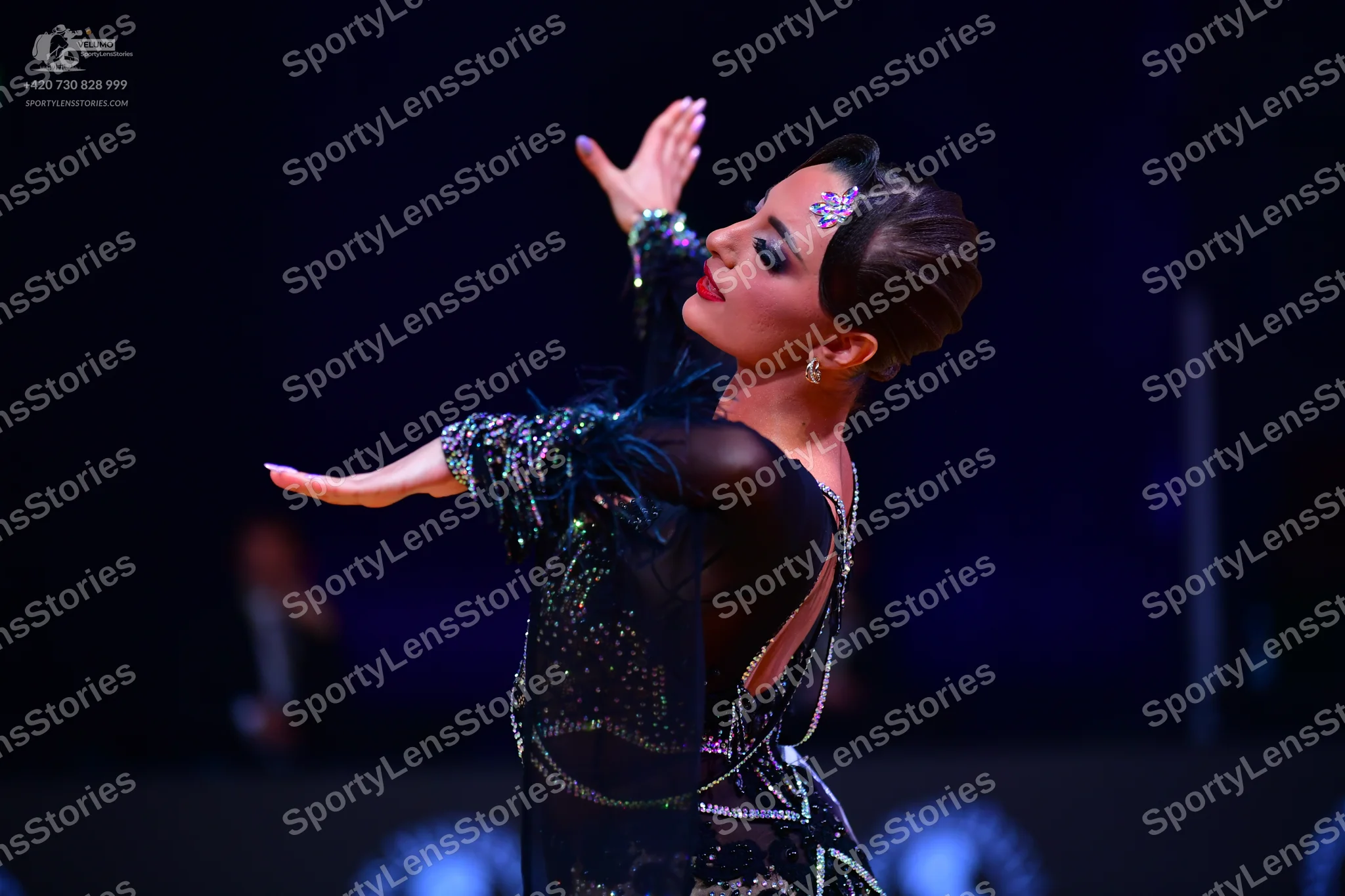 Dancesport competitor: Female dancer: black latin dance dress made of sheer black fabric with heavy sil