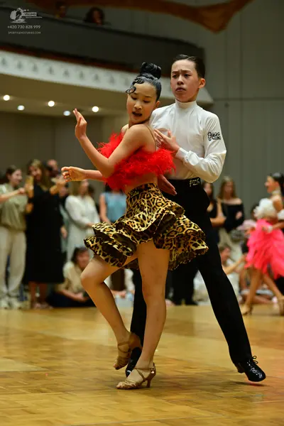 Dancesport competitor: Male dancer: white long-sleeved shirt and black trousers