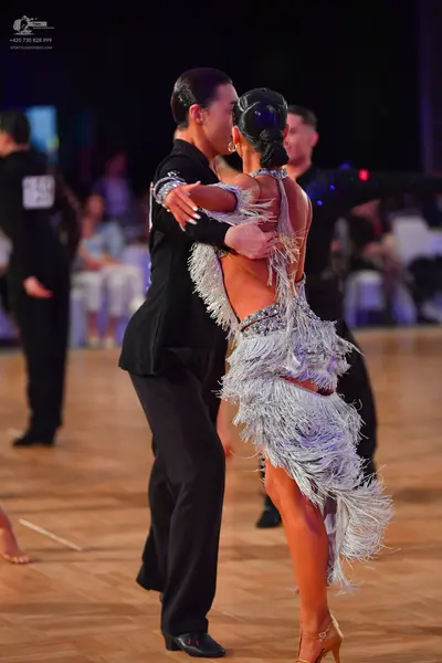 Dancesport competitor: Male dancer: black suit with silver sequined detail on the shoulder
