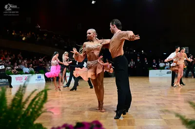 Dancesport competitor #45: Main female dancer: tan Latin dress with sequins, lace, and a ruffled skirt