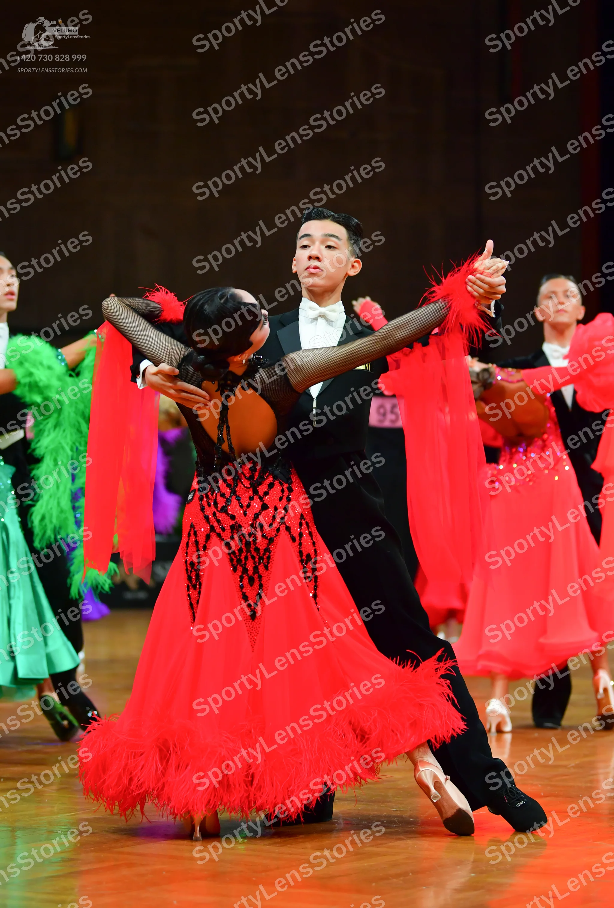 Dancesport competitor: Male dancers: black suits with white shirts and white bow ties