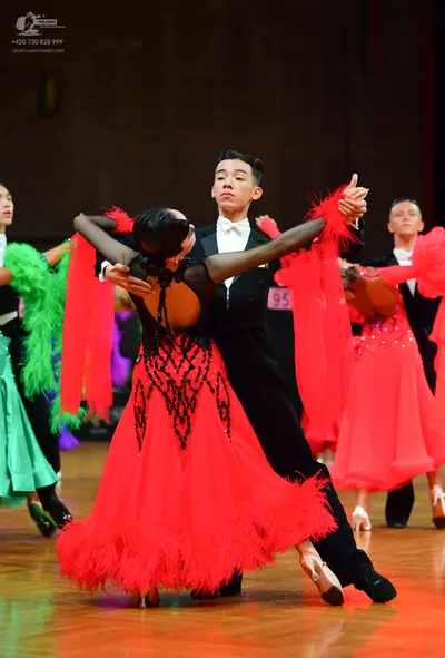 Dancesport competitor: Male dancers: black suits with white shirts and white bow ties