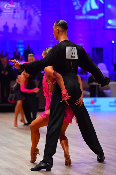 Dancesport competitor: Male dancer: black long-sleeved shirt and black trousers