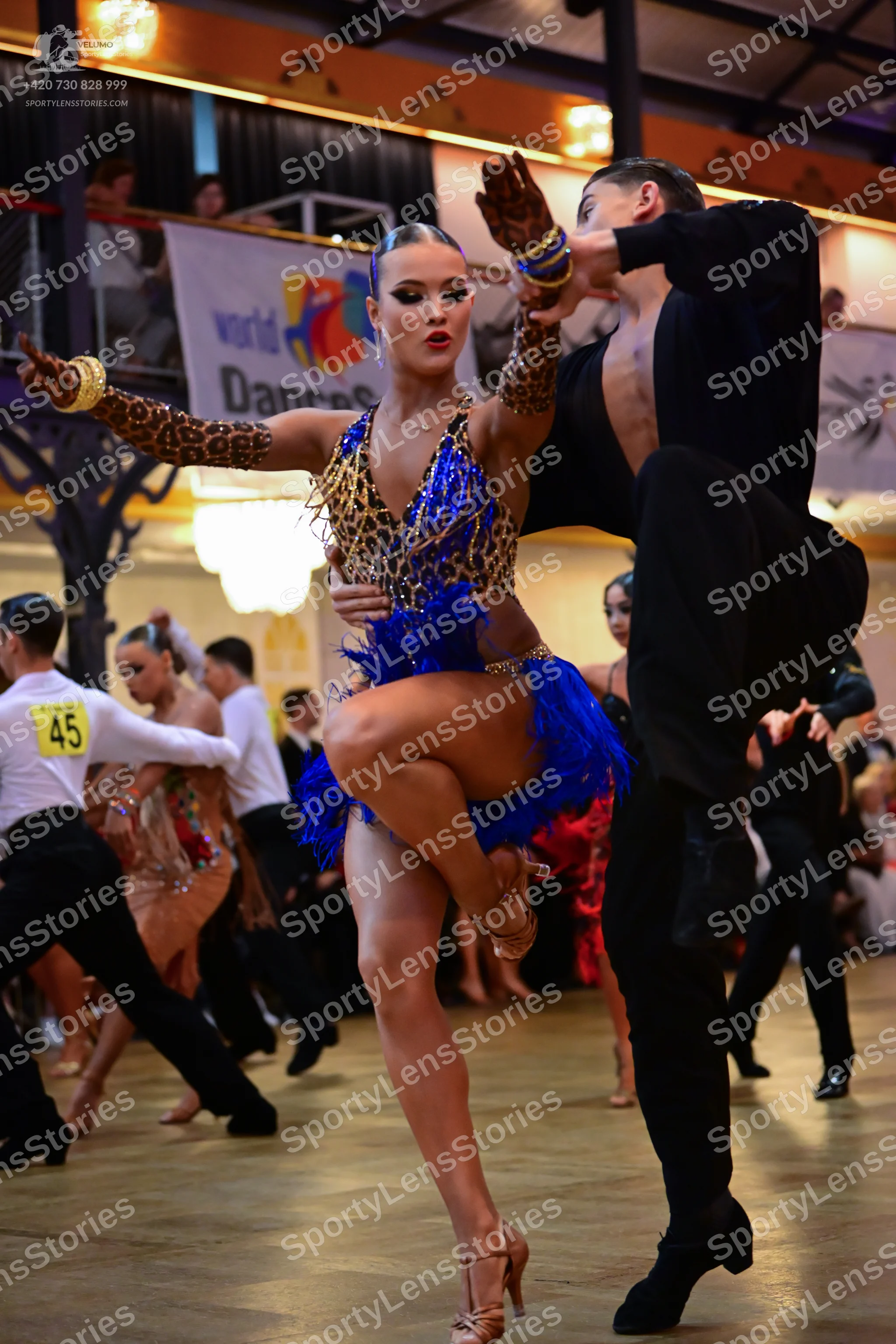Dancesport competitor #45: Main female dancer: leopard print top and long sleeves with a blue fringe skirt