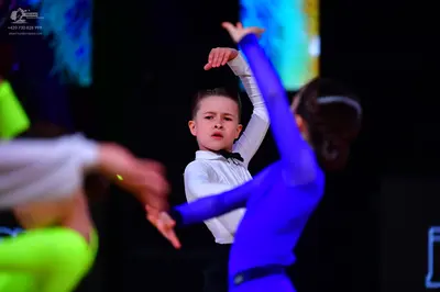Dancesport competitor: Boy dancer: white long-sleeved shirt with a black bow tie and black trousers