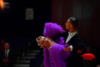 Dancesport competitor: Male dancer: black suit with a white shirt