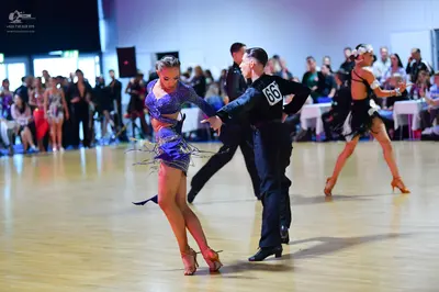 Dancesport competitor #66: Female dancer: purple latin dress with sequins and long sleeves