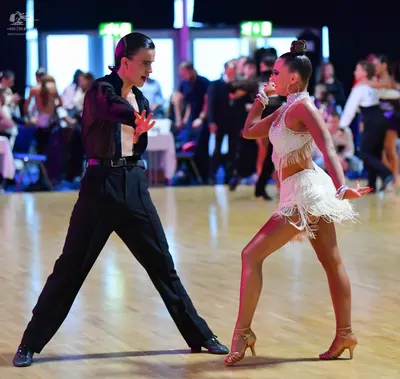 Dancesport competitor: Male dancer: black long-sleeved shirt and black trousers
