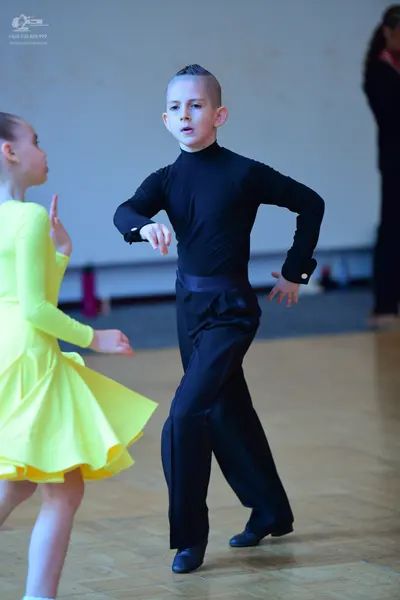 Dancesport competitor: Male dancer: black long-sleeved shirt and black trousers