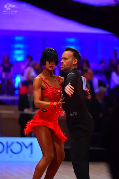 Dancesport competitor: Male dancer: black long-sleeve shirt and black trousers