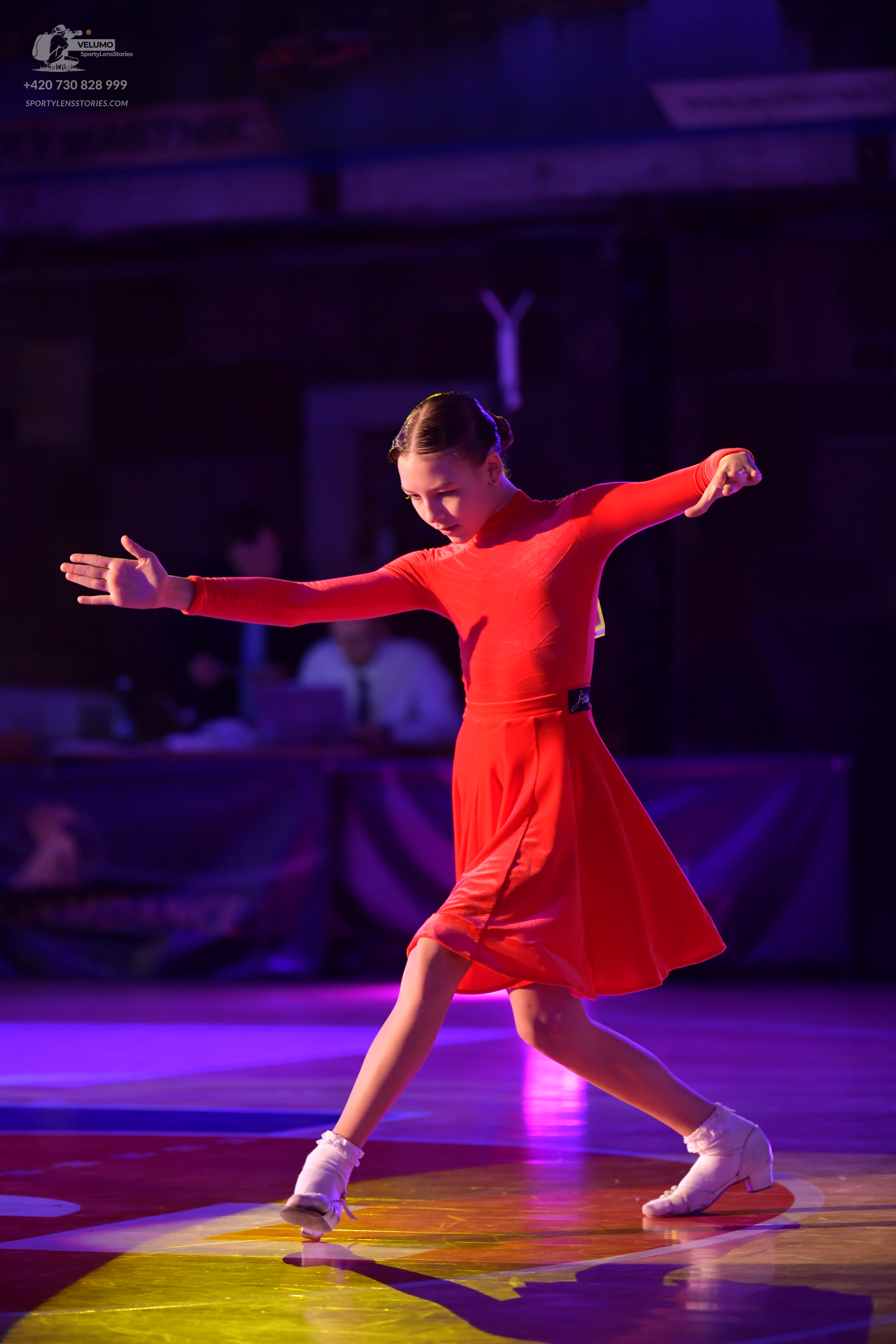 Dancesport competitor: Female dancer: red long-sleeved Latin dress