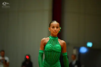 Dancesport competitor: Female dancer: bright green latin dress with sequin embellishments and matching 