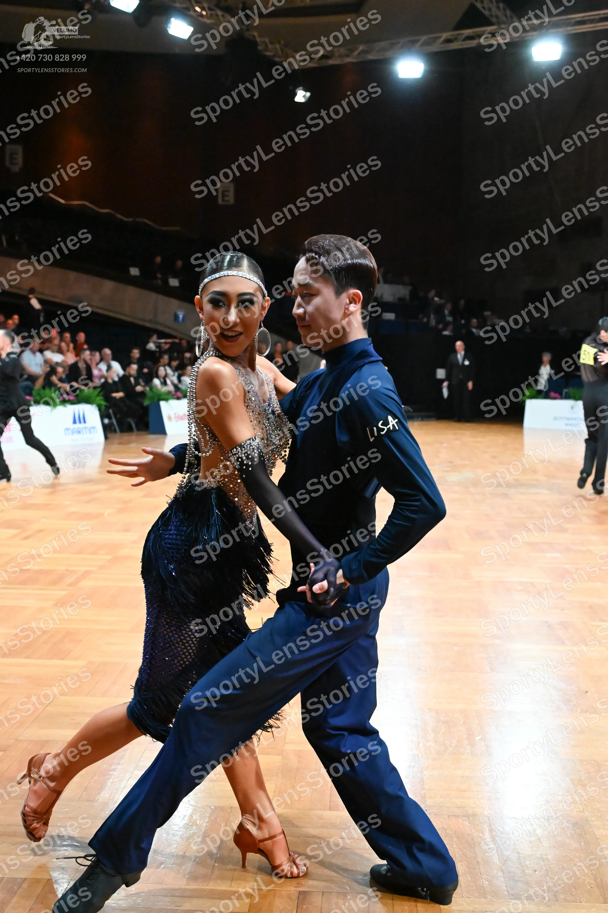 Dancesport competitor: Female dancer: dark blue Latin dress with silver sequin and rhinestone embellish