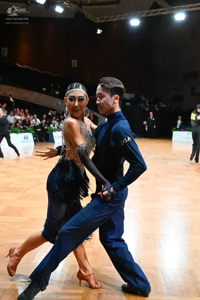 Dancesport competitor: Female dancer: dark blue Latin dress with silver sequin and rhinestone embellish