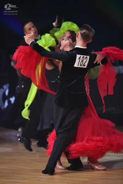 Dancesport competitor: Male dancer: black long-sleeved top and black trousers