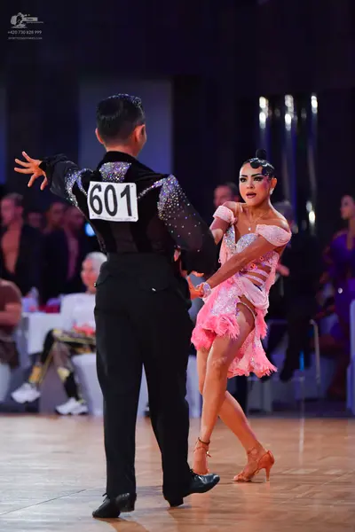 Dancesport competitor #601: Male dancer: black long-sleeved shirt with sequins on the upper back and black t