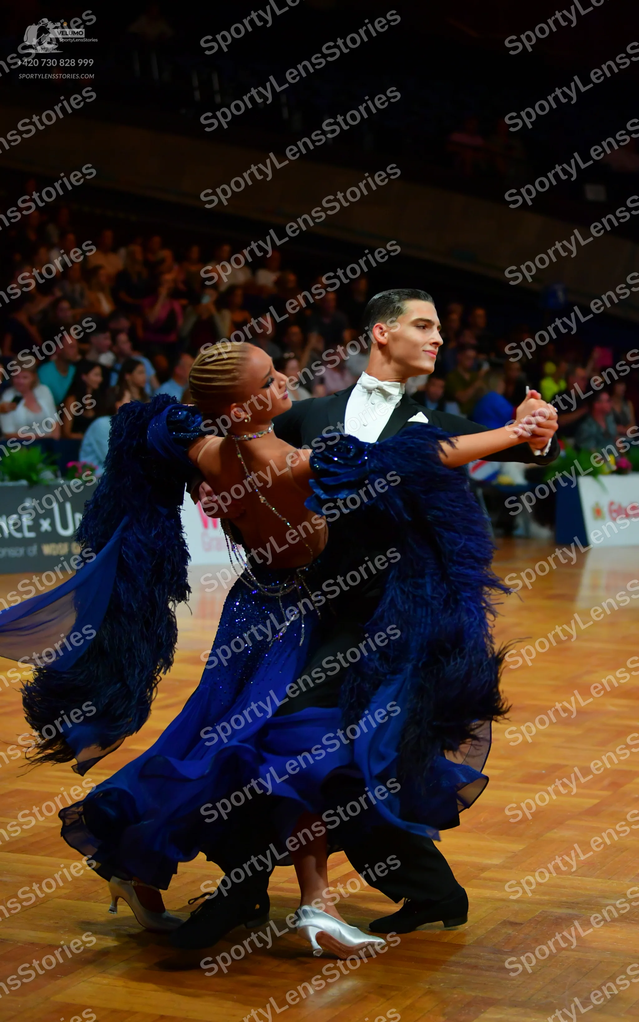 Dancesport competitor: Male dancer: black suit with a white shirt and white bow tie